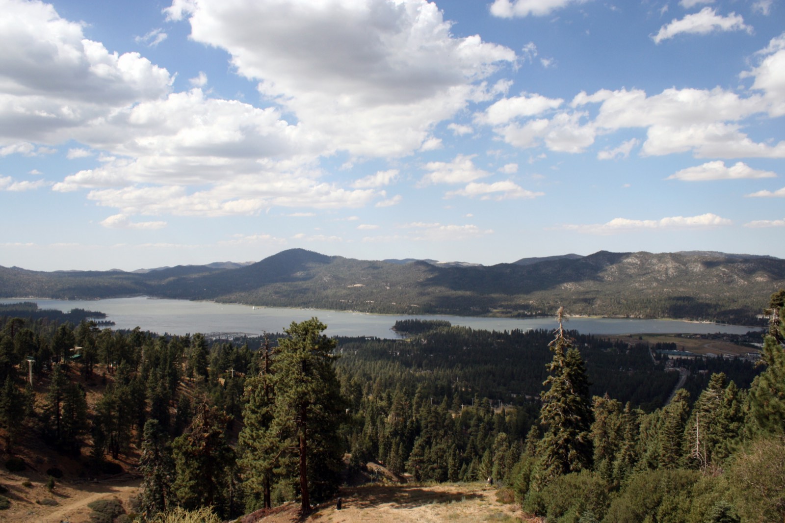 Big Bear Lake seen from the mountains above, ringed by forest.
